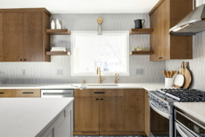 Kitchen with floating shelf and gold hardware.
