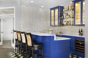 Basement wet bar with blue cabinetry