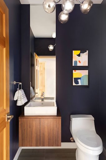 Bold powder room with fun light fixtures and bathroom trends.
