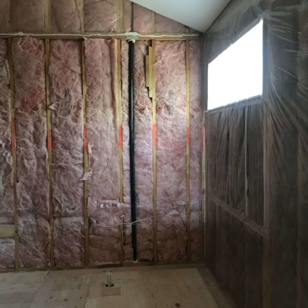 Insulation being applied to the interior walls of a home