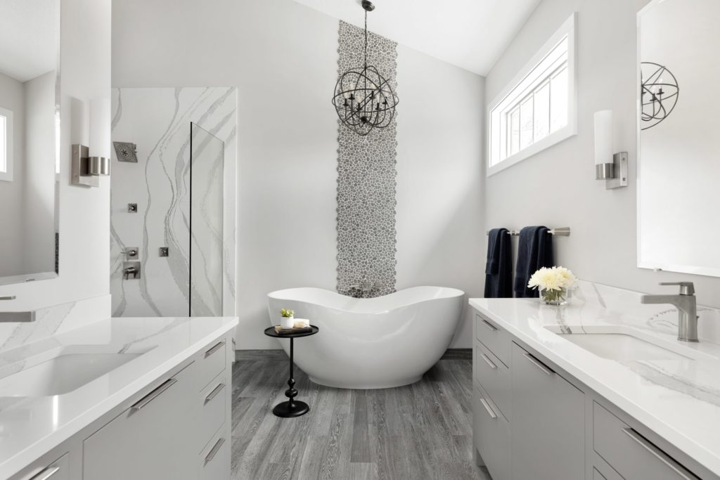 A large bath tub in a white and gray bathroom