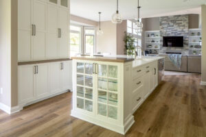A kitchen island that has a custom display case at one end.