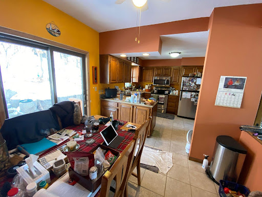 Yellow and orange kitchen and dining room before we remodeled.