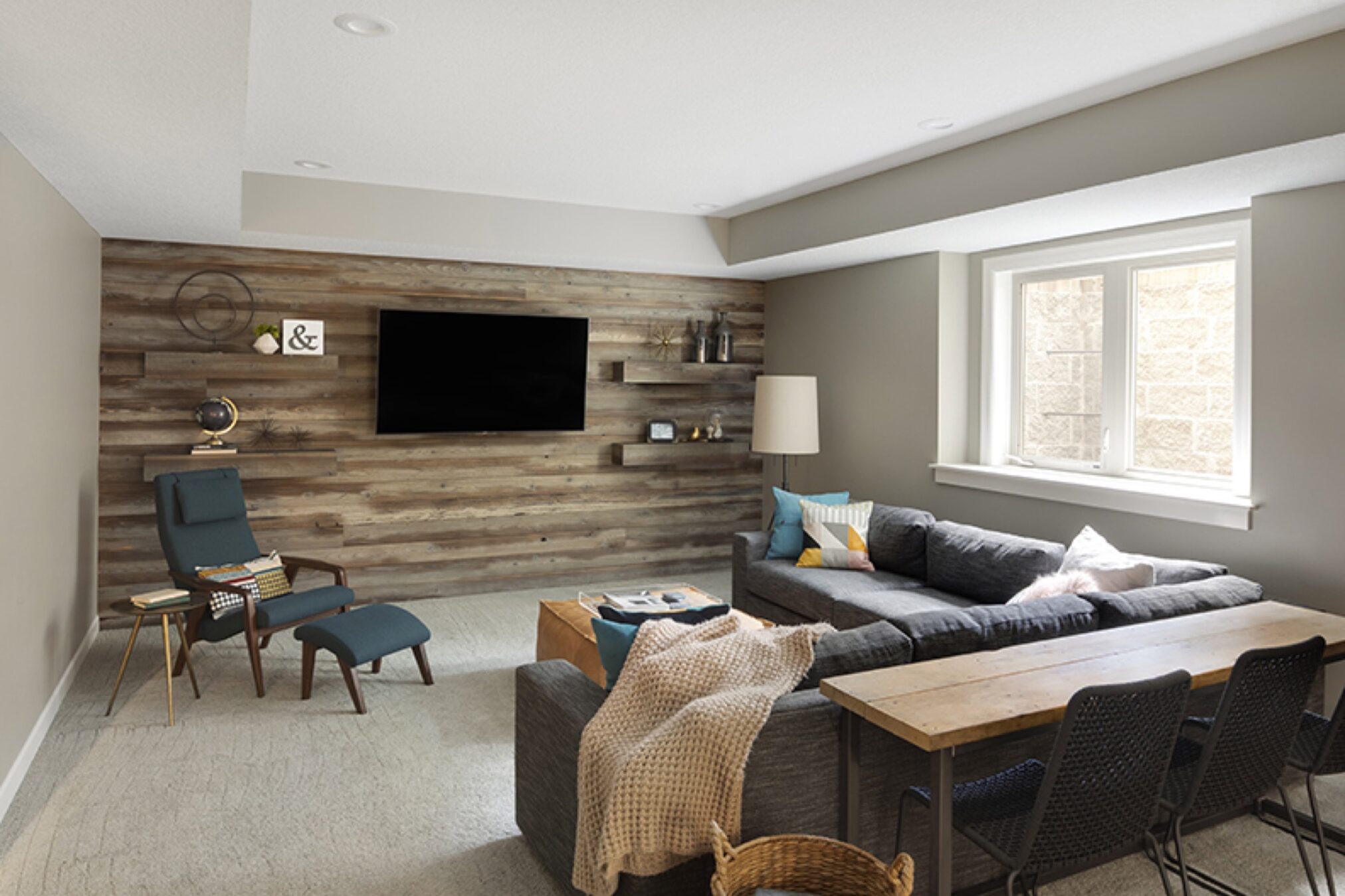 Basement TV room with wood paneling accent wall texture