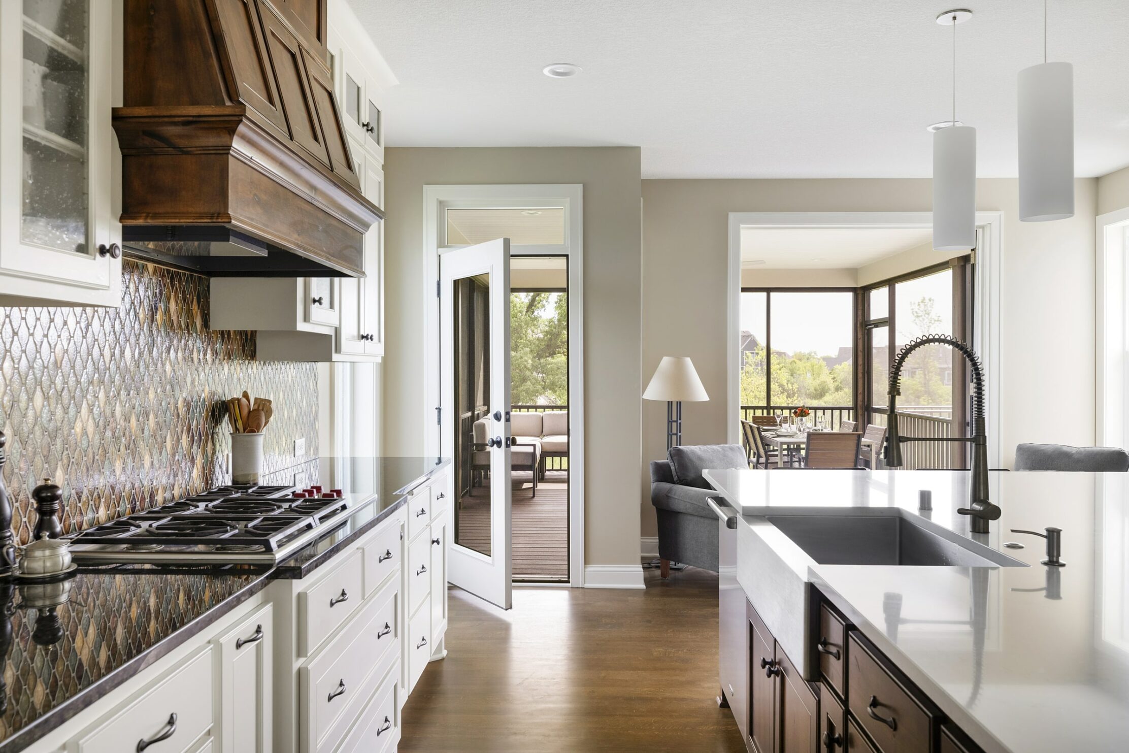 Kitchen with a dark wooden stove hood. Part of a James Barton Design-Build Remodel