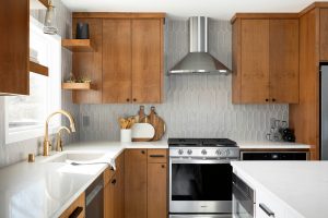 Wooden cabinets shining on a tiled backsplash in a kitchen