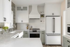 A kitchen with popping contrast in it's green, white, and black coloring