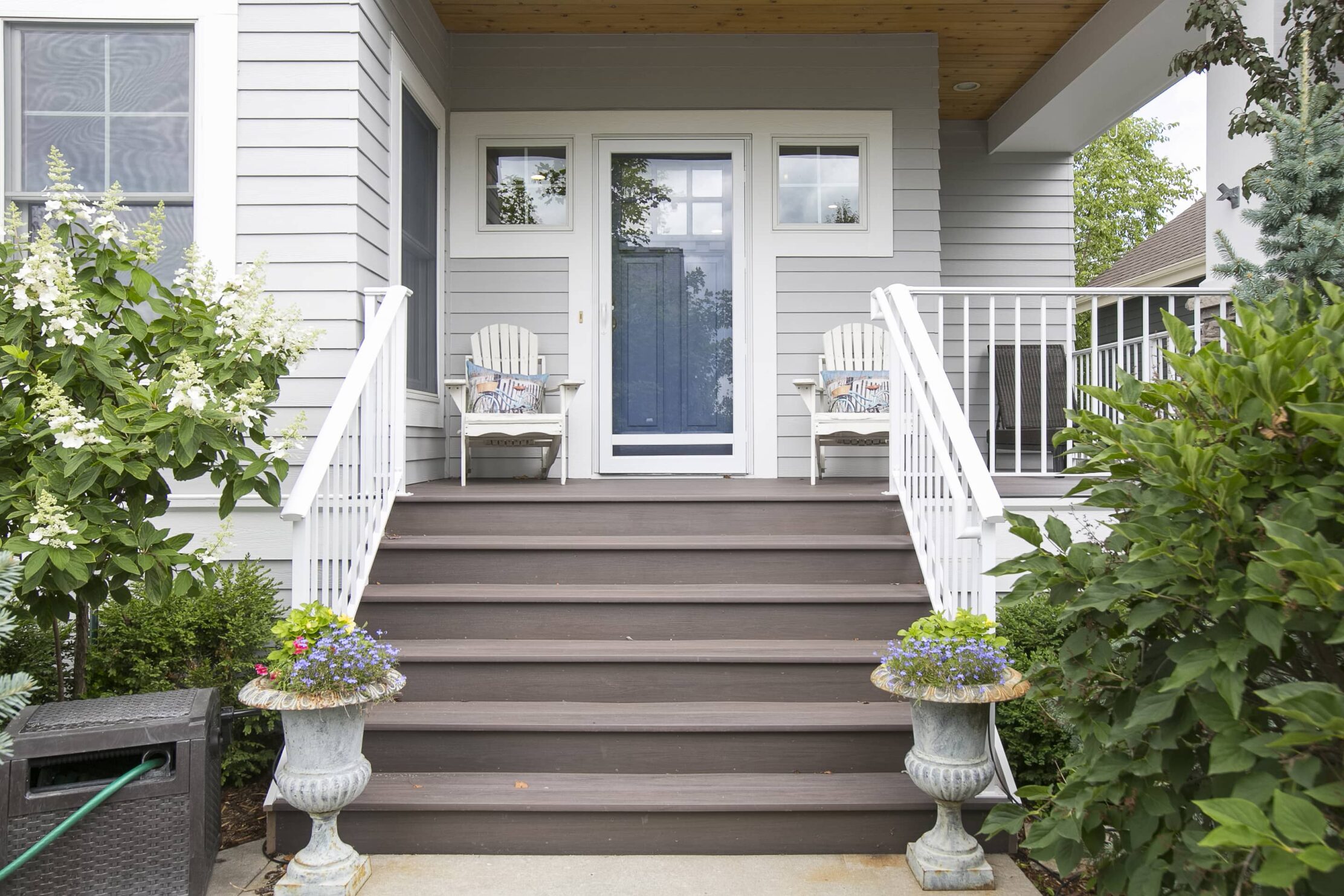 Minnesota exterior home remodel with light blue siding and navy blue door. 