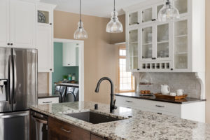 Kitchen with sink, fridge, cabinets, and countertop. Patterned kitchen countertops can be a beautiful addition to your remode