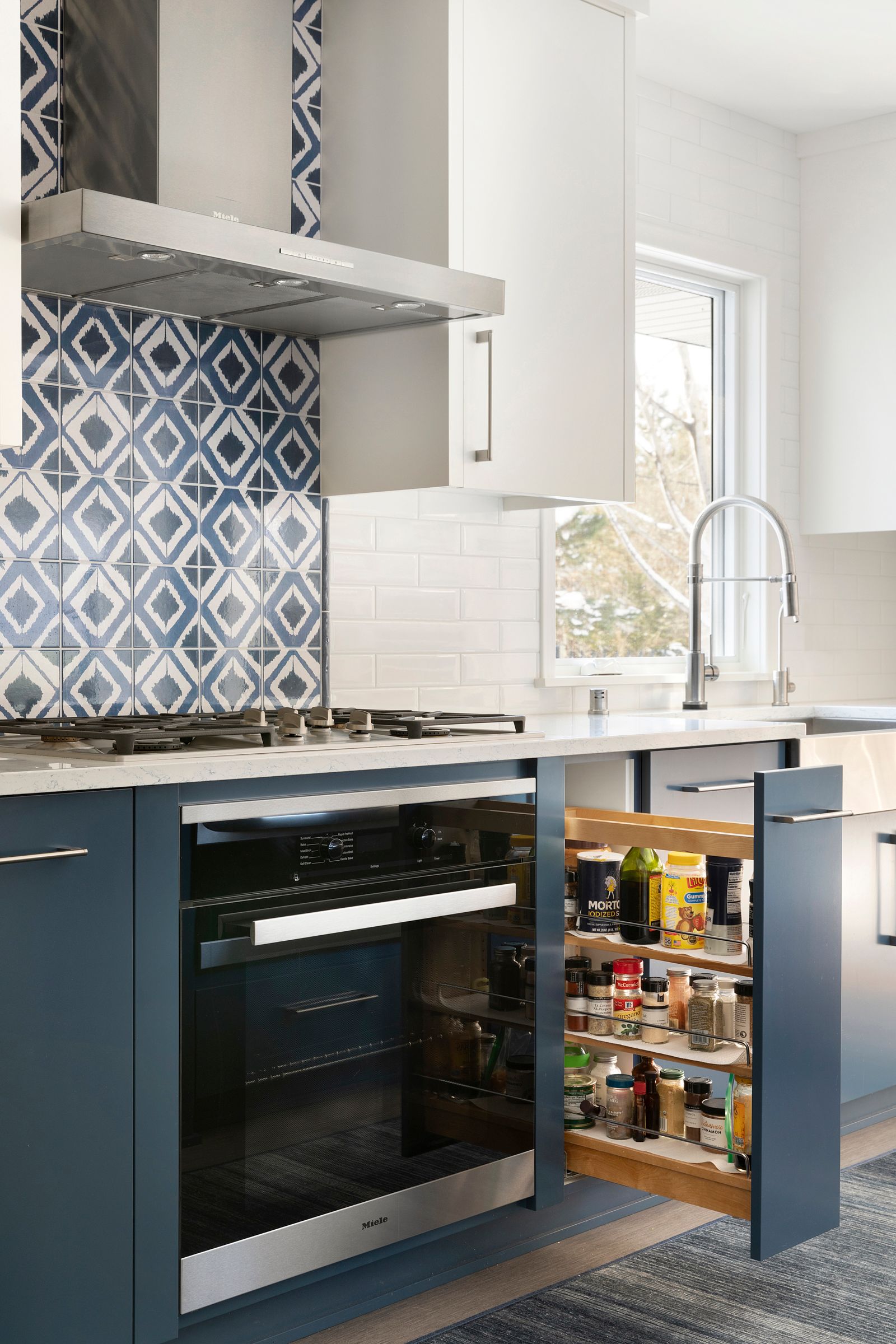 Minneapolis kitchen remodel with white and blue custom cabinets and pullout drawer.