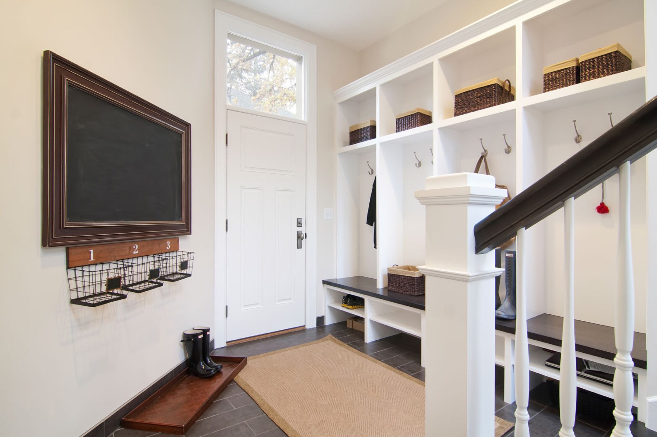 Mudroom with black chalkboard and cubbies for each member of the family. 