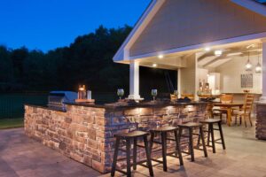 Outdoor space in Minnesota with extended island and chairs.