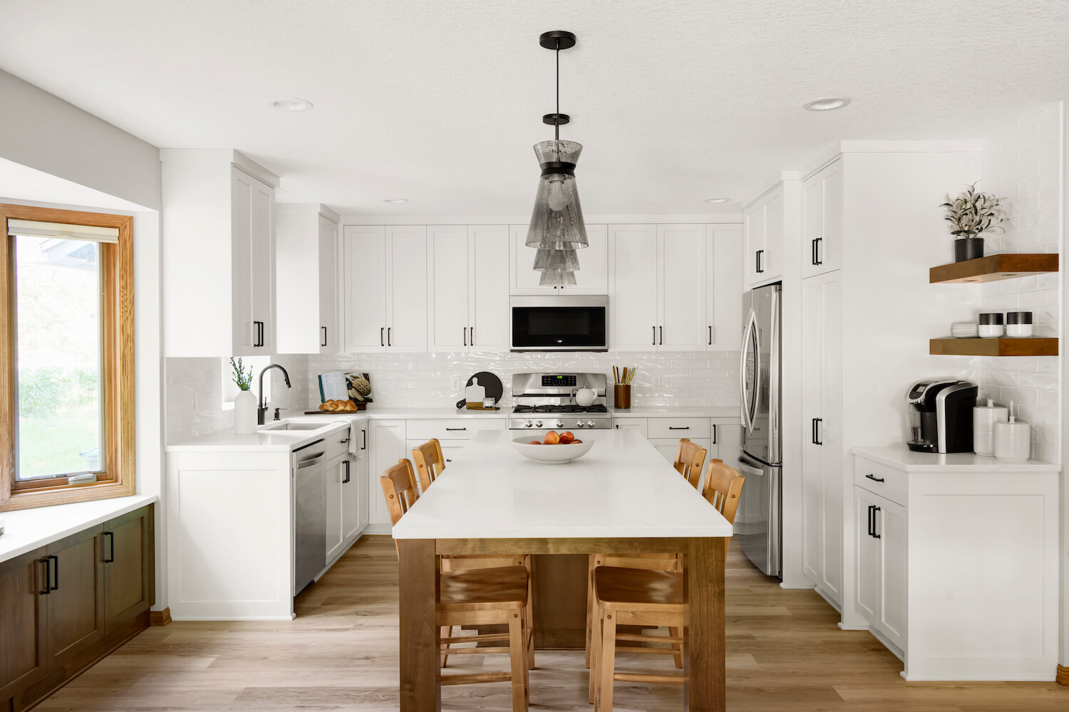 A kitchen with white cabinets and counters