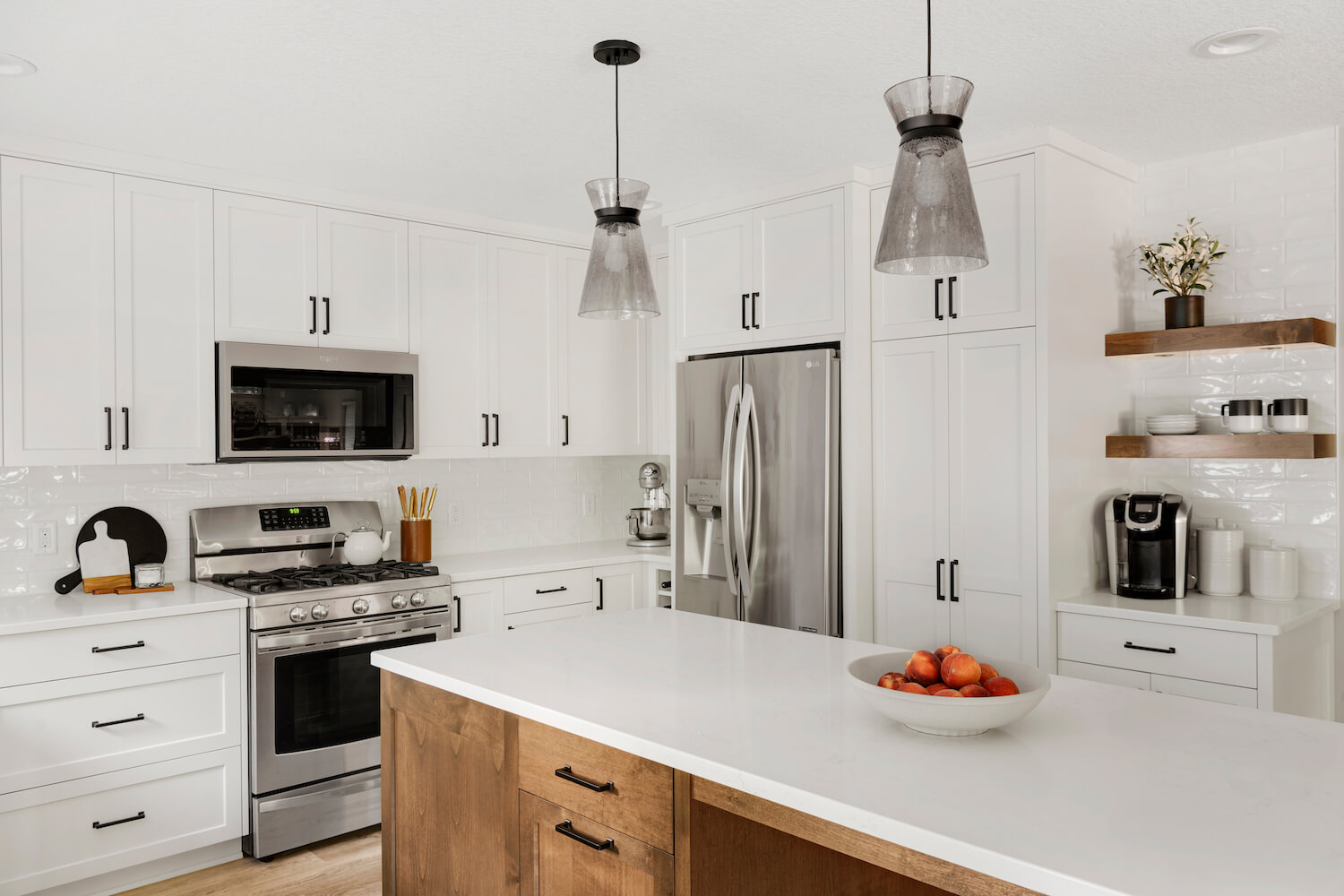 A home's kitchen with white cabinetry and counters