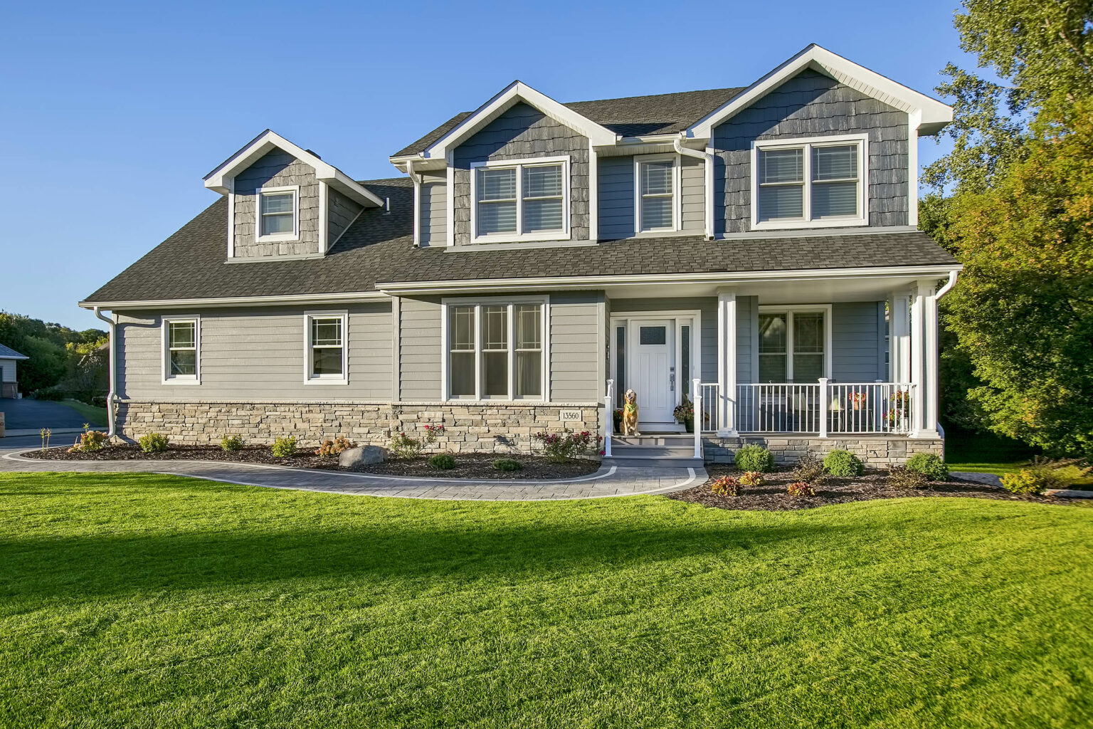 Minnesota home exterior with refreshed curb appeal and landscaping. Neutral tones.