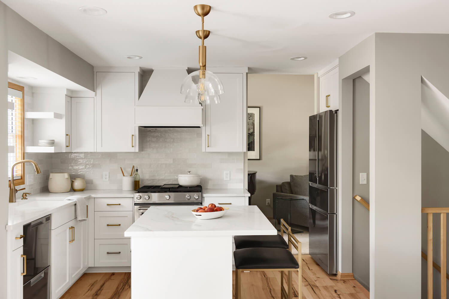 A white kitchen with stainless appliances