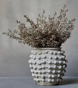 Fall decor with flowers in a white vase.