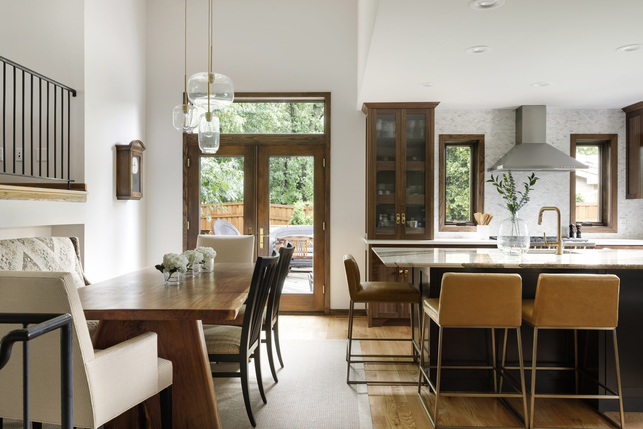 Dining room statement lighting in a chef's kitchen with brown wooden accents.