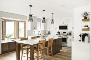 Kitchen remodel with a white island and pendant lamps