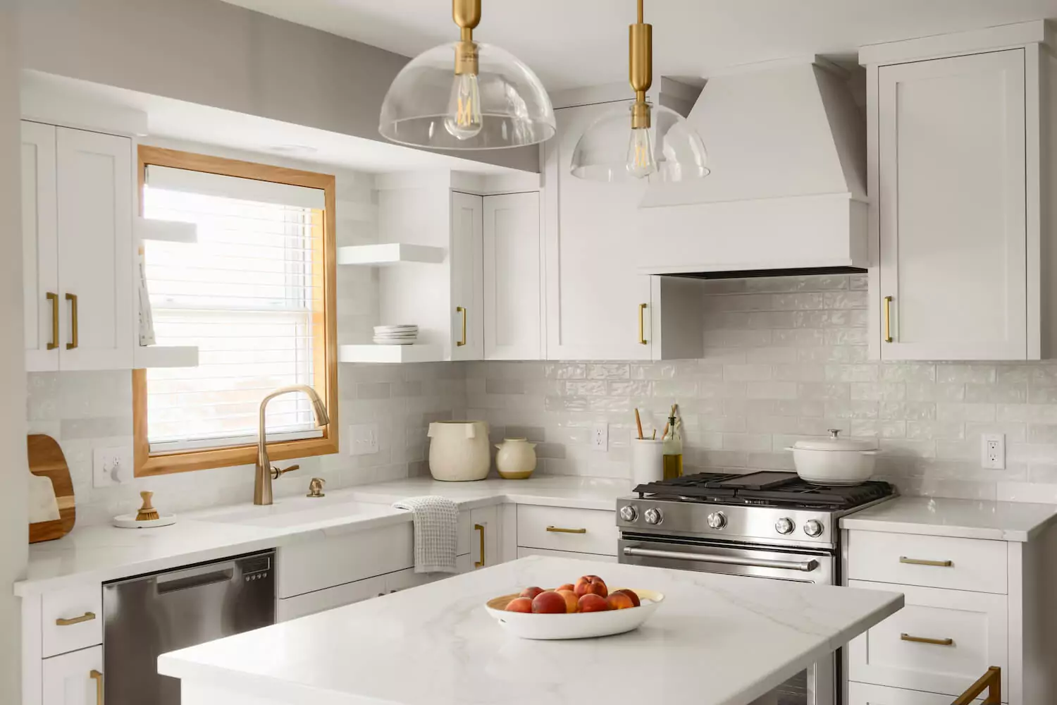 Monochromatic kitchen design with white as the primary color and gold accents.