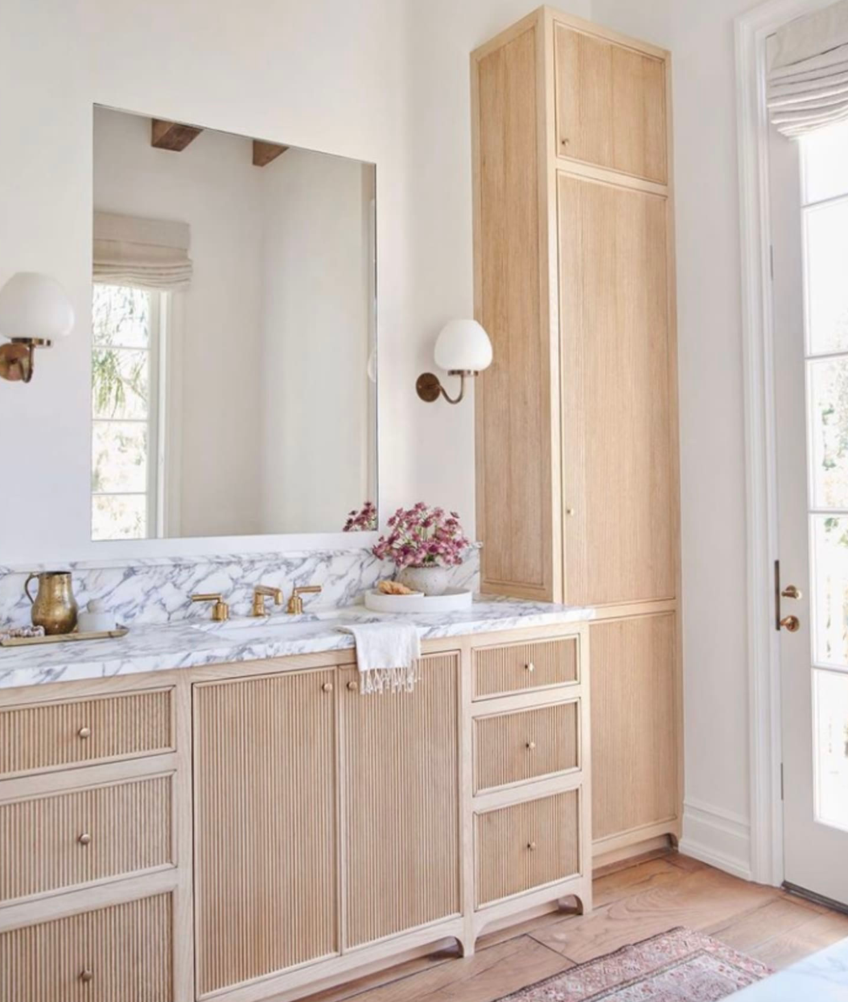 Reeded cabinets in a bathroom, with a light wooden color