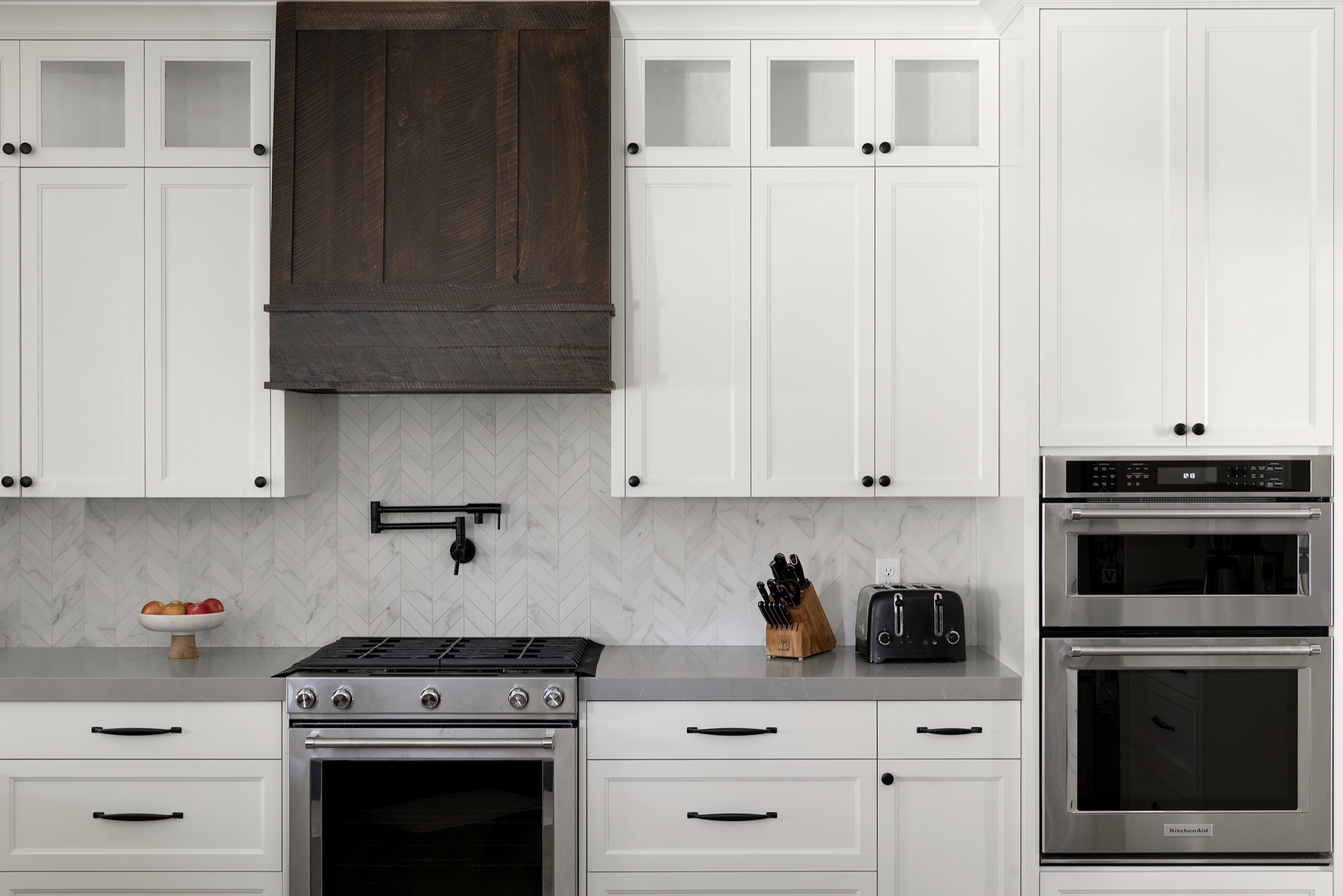 Updated chef's kitchen with double oven and white cabinetry in Modern Home