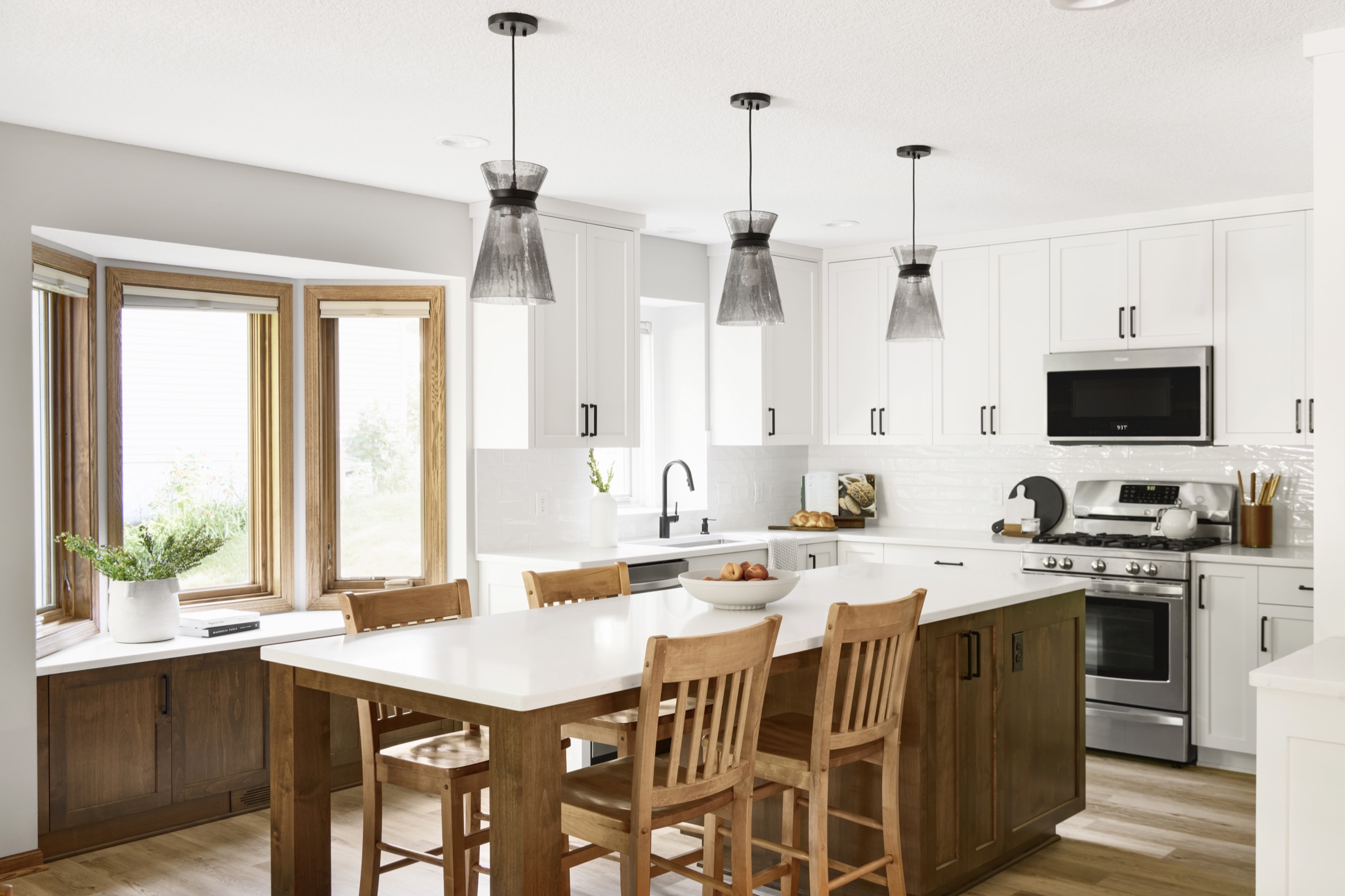 Chef's kitchen layout with white walls and cabinets and black accent lighting