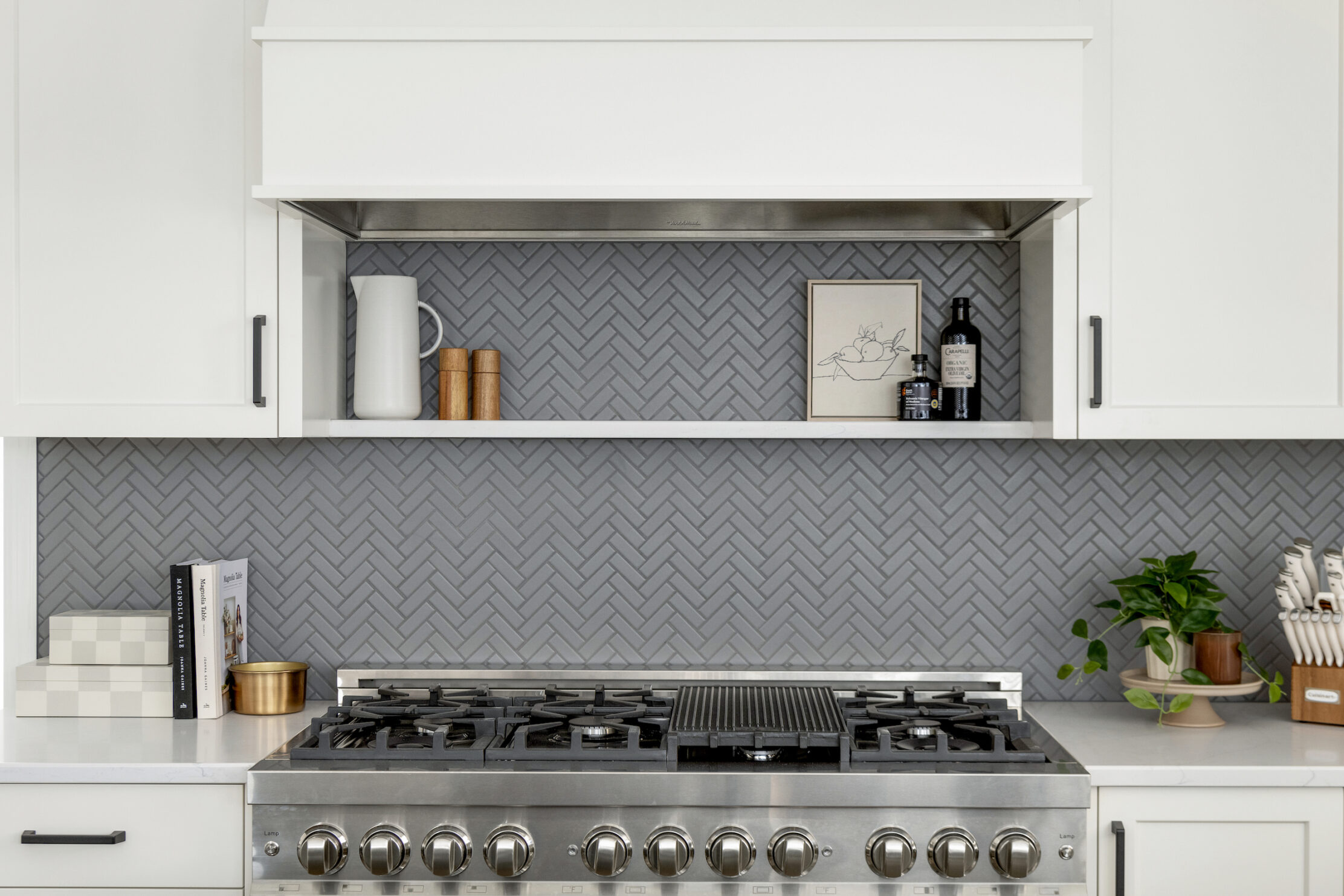 Textured kitchen backsplash with white cabinetry