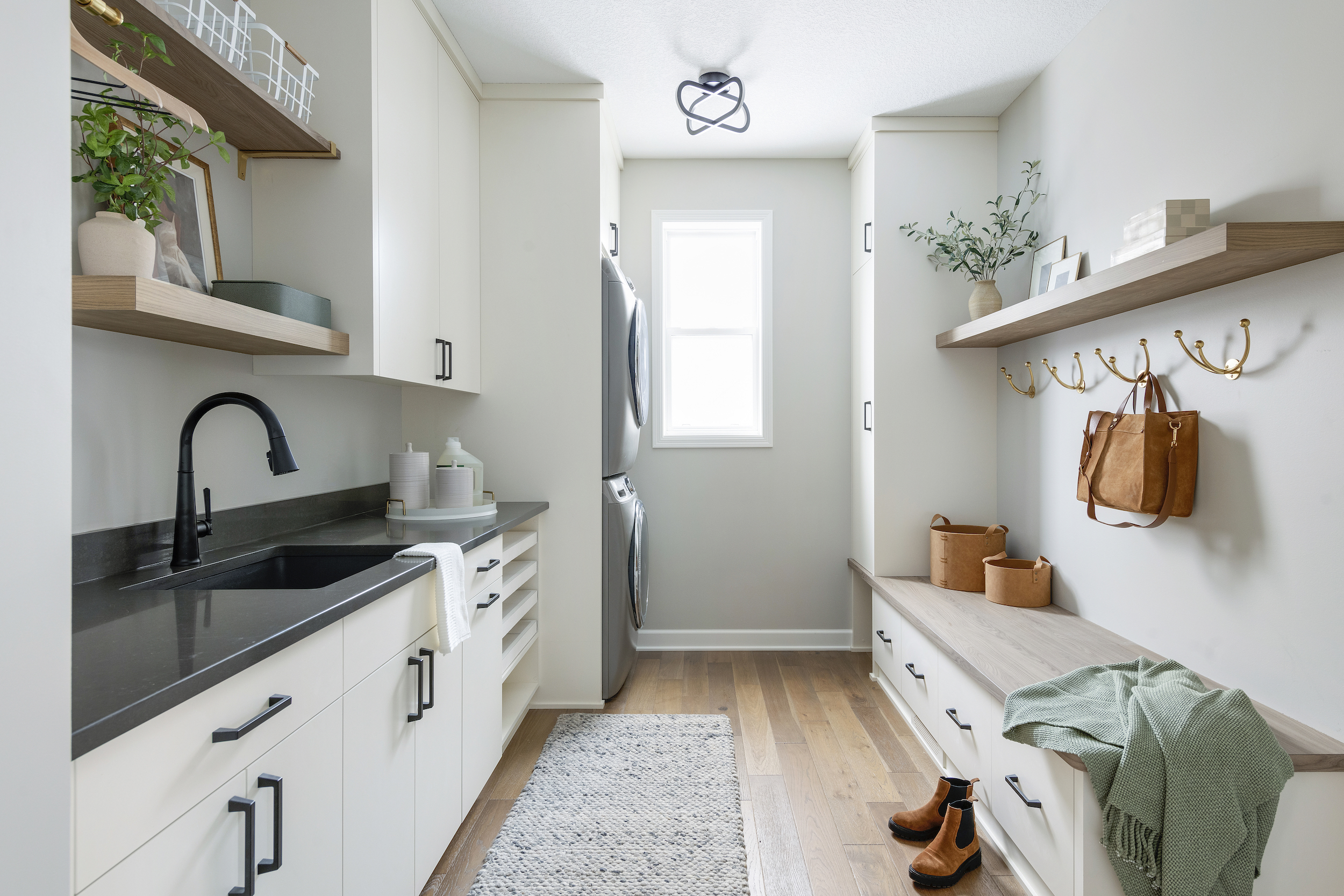 Mudroom/laundry room ideas with black countertop and natural light.