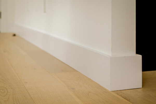 White modern baseboard with eased edge.