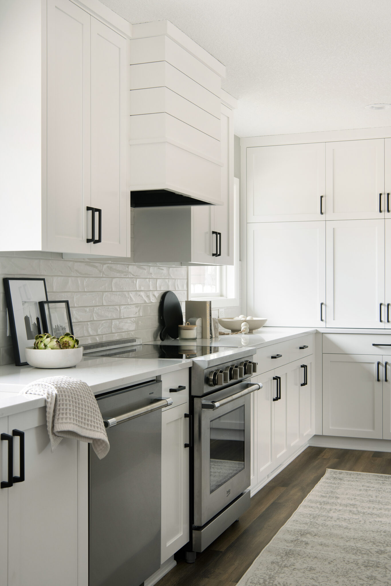 Newly remodeled white kitchen with black accents and appliances