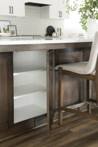 Kitchen island that has storage underneath with a wood-legged chair set nearby