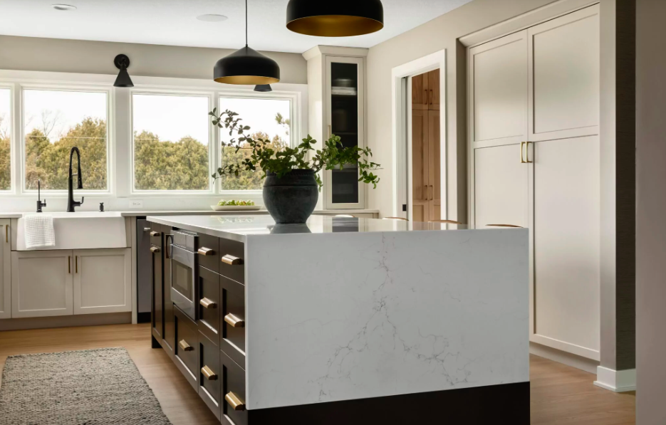 white kitchen countertop with waterfall edge and dark wood cabinetry