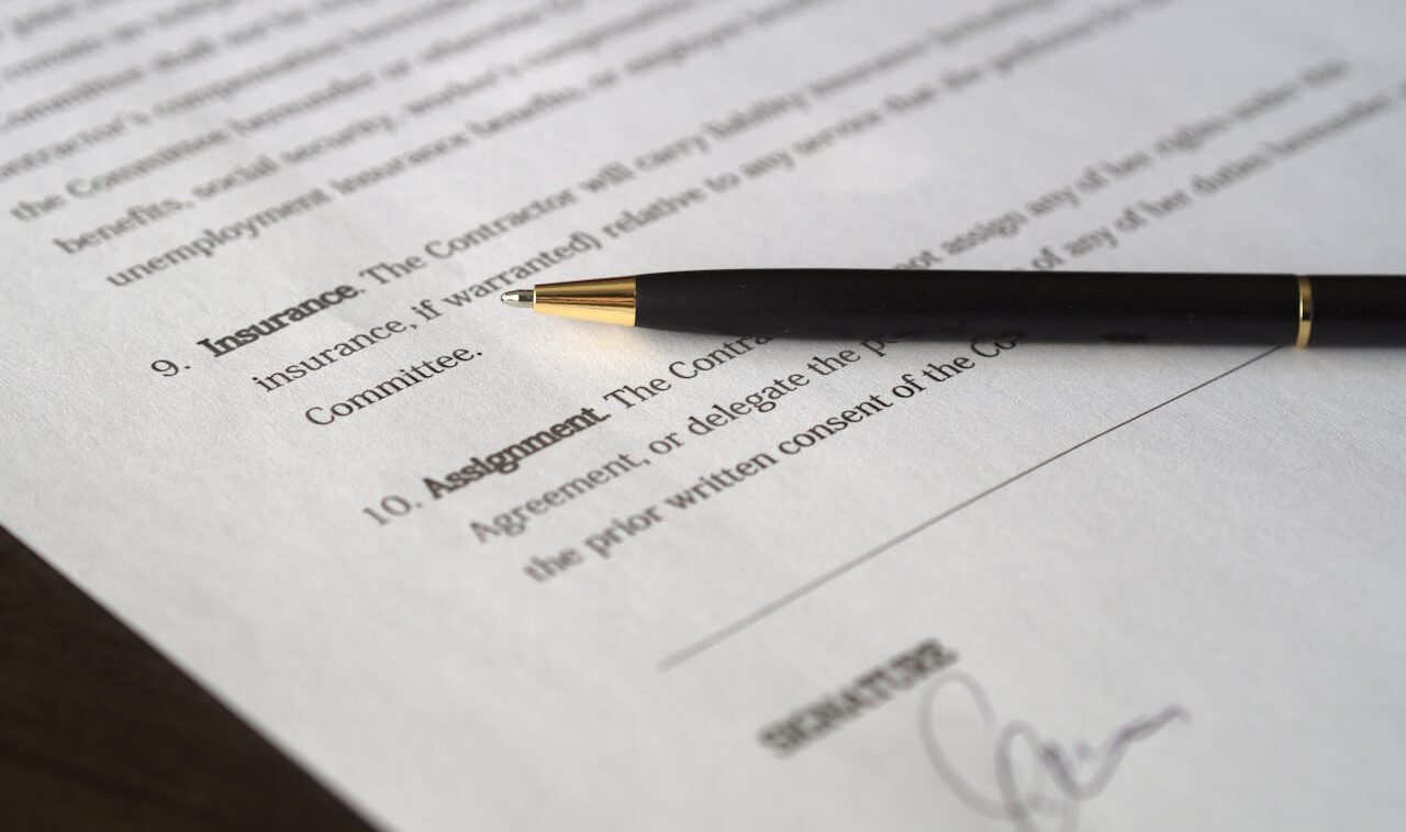 pen laying on a signed paper contract