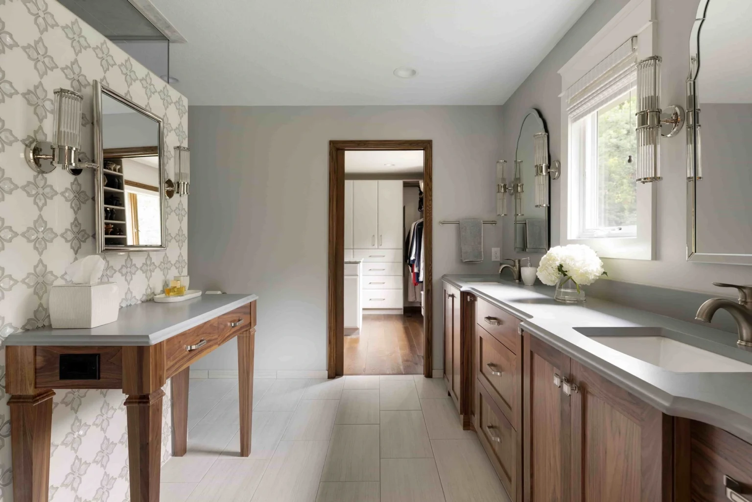 Modern gray bathroom with a brown wooden pocket door that opens to a walk-in closet